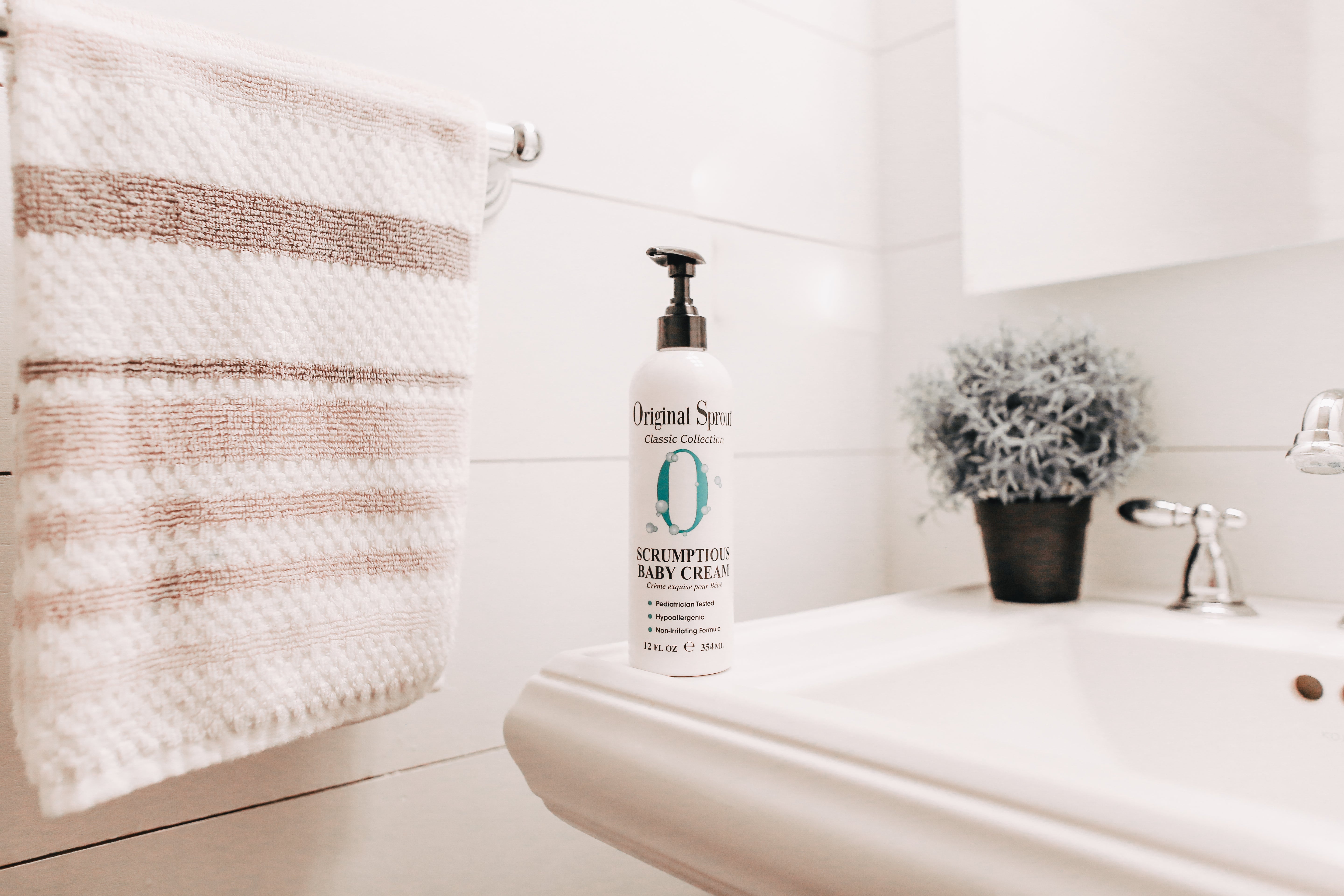 12 oz Scrumptious Baby Cream set on a bathtub 