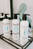 Three bottles of Original Sprout Classic Collection on a bathroom shelf.