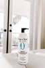 Bottle of Original Sprout Deep Conditioner on a white surface with a blurred background