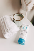 Load image into Gallery viewer, Tube of Original Sprout Scrumptious Baby Cream with a candle and towel on a neutral background